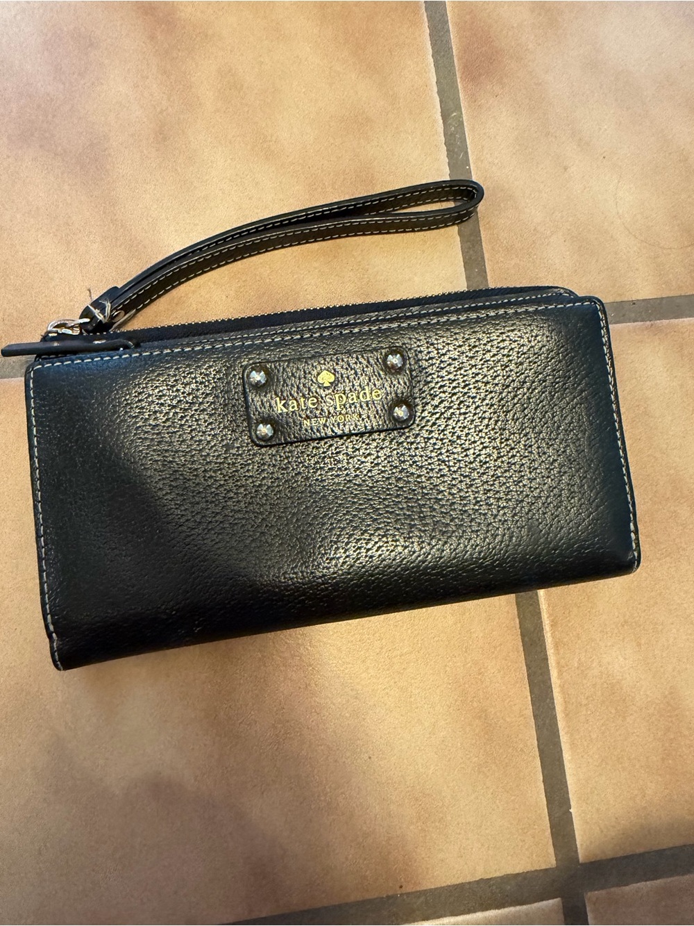 kate spade black leather wristlet with gold logo plate